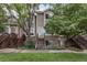 Charming multi-level home with brick accents, lush green lawn and mature shade trees enhance curb appeal at 1885 S Quebec Way # G104, Denver, CO 80231