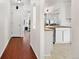 Hallway leading to a kitchen featuring white cabinets, wood countertops, and stainless steel appliances at 1885 S Quebec Way # G104, Denver, CO 80231