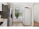 Bright kitchen with stainless steel refrigerator, ample counter space, and a large window for natural light at 1885 S Quebec Way # G104, Denver, CO 80231