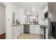 Well-lit kitchen with stainless steel appliances, ample counter space and sleek white cabinetry for efficient cooking at 1885 S Quebec Way # G104, Denver, CO 80231