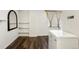 Room featuring laminate wood flooring, white walls, built in shelves, and a freezer at 1885 S Quebec Way # G104, Denver, CO 80231