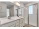 Bathroom with a double vanity, modern fixtures, and a glass-enclosed shower at 16794 W 94Th Way, Arvada, CO 80007