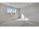 Bright bedroom with carpet and view through windows at 16794 W 94Th Way, Arvada, CO 80007