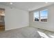 Bedroom with carpet flooring, two windows and an entrance to the bathroom at 16794 W 94Th Way, Arvada, CO 80007