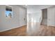 Bright entryway with hardwood floors, a staircase, and a view into the main living area at 16794 W 94Th Way, Arvada, CO 80007
