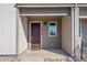 Inviting front porch with stylish front door, house numbers and window at 16794 W 94Th Way, Arvada, CO 80007