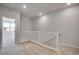 Hallway with white railing, carpet flooring, and doors to other rooms with natural light at 16794 W 94Th Way, Arvada, CO 80007