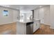 Elegant kitchen island with quartz countertop, stainless steel dishwasher, and brass hardware at 16794 W 94Th Way, Arvada, CO 80007