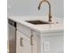 Close up on modern kitchen island with quartz countertop and stainless steel dishwasher at 16794 W 94Th Way, Arvada, CO 80007