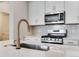 Close-up of kitchen island with stainless sink, and stylish faucet at 16794 W 94Th Way, Arvada, CO 80007