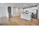 Modern kitchen with stainless steel appliances, a kitchen island, and stairs to the second level at 16794 W 94Th Way, Arvada, CO 80007