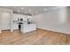 Open-concept kitchen featuring white cabinets, stainless steel appliances, and a kitchen island at 16794 W 94Th Way, Arvada, CO 80007