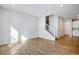Spacious living room with hardwood floors, staircase, and neutral paint, perfect for entertaining at 16794 W 94Th Way, Arvada, CO 80007