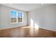 Bright and airy living room with hardwood floors and large windows offering ample natural light at 16794 W 94Th Way, Arvada, CO 80007