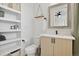 Modern bathroom features a floating vanity, mirror, and open shelving for storage at 3101 W 47Th Ave # 14, Denver, CO 80211