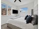 Modern bedroom featuring a ceiling fan, tv, and a large window offering plenty of natural light at 3101 W 47Th Ave # 14, Denver, CO 80211