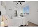 Bright bedroom featuring a ceiling fan, a plant near the window, and an ensuite bathroom at 3101 W 47Th Ave # 14, Denver, CO 80211