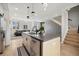 Chic kitchen island with seating, stainless steel dishwasher, hardwood floors, and living area in background at 3101 W 47Th Ave # 14, Denver, CO 80211