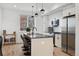 Contemporary kitchen featuring an island with seating, stainless steel appliances, and a sleek modern design at 3101 W 47Th Ave # 14, Denver, CO 80211