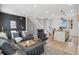 Spacious living room with staircase featuring comfortable seating and modern kitchen area at 3101 W 47Th Ave # 14, Denver, CO 80211