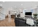 Open-concept living space with a modern kitchen, gray sofa, and an entertainment center beneath bright windows at 3101 W 47Th Ave # 14, Denver, CO 80211