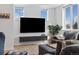 Relaxing living room featuring a large television, comfortable seating and plenty of natural light from the large windows at 3101 W 47Th Ave # 14, Denver, CO 80211