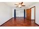 Open bedroom with hardwood floors, an open closet, and neutral walls ready for customization at 9125 Lowell Ct, Westminster, CO 80031