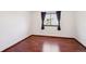 Minimalist bedroom featuring hardwood floors, a window with curtains, and clean, neutral walls at 9125 Lowell Ct, Westminster, CO 80031