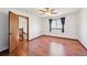 Inviting bedroom with hardwood floors, a ceiling fan, and a doorway to another level at 9125 Lowell Ct, Westminster, CO 80031