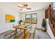 Bright dining room with modern table, decor and natural light with two windows and a view at 9125 Lowell Ct, Westminster, CO 80031