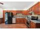 Well-lit kitchen featuring wood cabinets, stainless steel appliances, and a stylish backsplash at 9125 Lowell Ct, Westminster, CO 80031