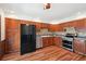 Updated kitchen with stainless steel appliances, wooden cabinets, tiled backsplash, and wood floors at 9125 Lowell Ct, Westminster, CO 80031