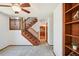 Inviting living room featuring wood railing staircase, ceiling fan, neutral colored carpet and natural light at 9125 Lowell Ct, Westminster, CO 80031