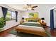 Serene bedroom with a large window, modern furniture, wood floors, and ample closet space at 9125 Lowell Ct, Westminster, CO 80031