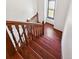 Elegant wooden staircase leading to the upper level, enhanced by natural light from a window at 9125 Lowell Ct, Westminster, CO 80031