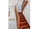 Elegant wood staircase with natural light, featuring carpeted steps and white walls at 9125 Lowell Ct, Westminster, CO 80031