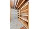 Basement storage room with unfinished floor and wooden shelving at 9125 Lowell Ct, Westminster, CO 80031