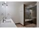 Modern bathroom with double sinks, spacious shower with glass door, and soaking tub at 1750 Wewatta St # 1102, Denver, CO 80202
