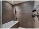 Modern bathroom with tile surround, rainfall shower head, soaking tub, and built-in shelves at 1750 Wewatta St # 1102, Denver, CO 80202