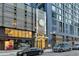 Modern building exterior with street-level retail space and prominent signage at 1750 Wewatta St # 1102, Denver, CO 80202