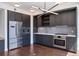Modern kitchen featuring stainless steel appliances, sleek gray cabinets, and hardwood floors at 1750 Wewatta St # 1102, Denver, CO 80202