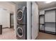 Convenient laundry room featuring stacked washer and dryer, plus shelving for storage at 1750 Wewatta St # 1102, Denver, CO 80202