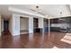 Open-concept living area with hardwood floors and sliding doors to another room at 1750 Wewatta St # 1102, Denver, CO 80202