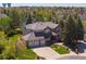 Stunning aerial view of brick home with mature trees and a well-manicured lawn in a desirable neighborhood at 9980 Newton Ct, Westminster, CO 80031