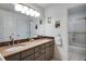 This bathroom features double sinks, gray cabinets, and a tile backsplash at 9980 Newton Ct, Westminster, CO 80031