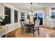 Bright dining room with hardwood floors, modern chandelier, and sliding glass door at 9980 Newton Ct, Westminster, CO 80031