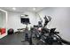 This home gym offers exercise equipment, a wall mounted television, and rubber floors at 9980 Newton Ct, Westminster, CO 80031