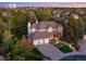 Beautiful brick home featuring a three-car garage, mature trees, and professional landscaping at 9980 Newton Ct, Westminster, CO 80031