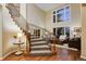 Elegant foyer featuring a grand staircase, hardwood floors, and abundant natural light at 9980 Newton Ct, Westminster, CO 80031