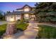 Charming front entrance with brick accents, manicured landscaping, and a welcoming pathway at 9980 Newton Ct, Westminster, CO 80031